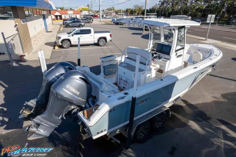 Slide: The Image of 2021 Sea Hunt Ultra 265 SE boat with dual Yamaha engines in a parking lot. - 42