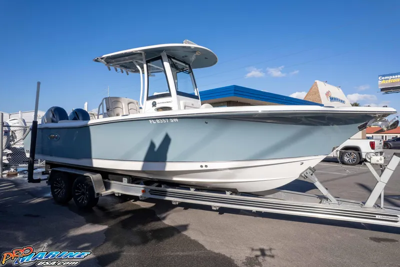 Slide: The Image of 2021 Sea Hunt Ultra 265 SE boat on trailer under clear blue sky. - 43