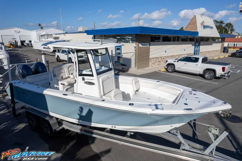 Slide: The Image of 2021 Sea Hunt Ultra 265 SE boat on trailer at marina dealership. - 44