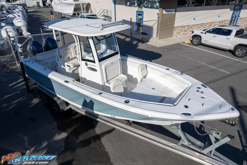 Slide: The Image of 2021 Sea Hunt Ultra 265 SE boat on trailer at dealership, showcasing sleek design and spacious deck. - 45