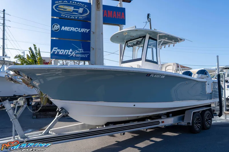 Slide: The Image of 2021 Sea Hunt Ultra 265 SE boat on trailer at dealership. - 5