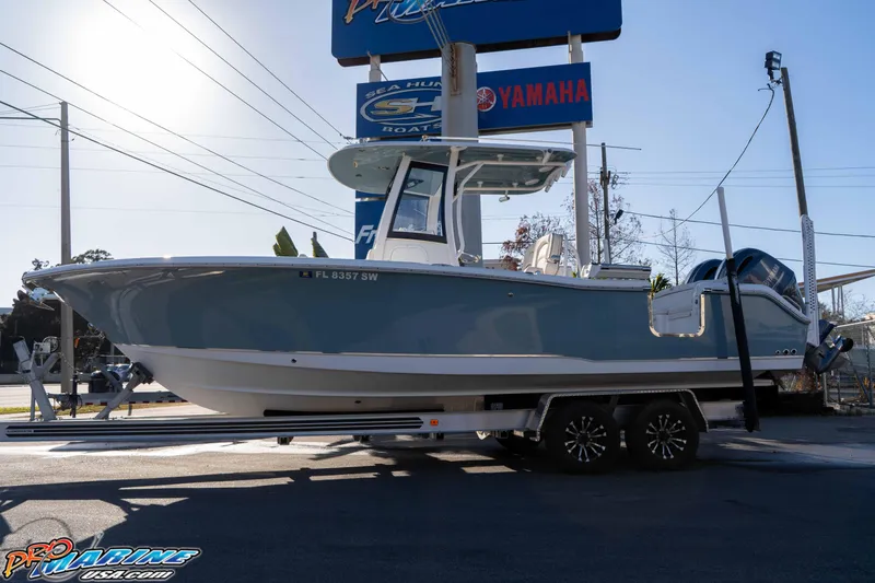 Slide: The Image of 2021 Sea Hunt Ultra 265 SE boat on trailer at dealership, sunny day. - 6