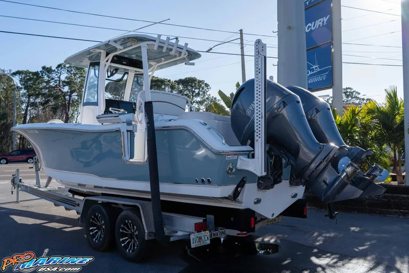 Slide: The Image of 2021 Sea Hunt Ultra 265 SE boat on trailer, featuring dual outboard engines. - 9