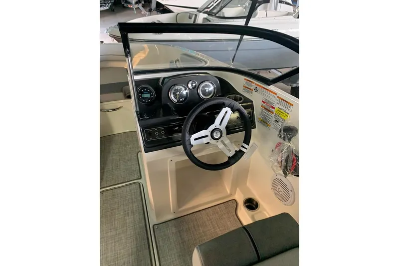 Slide: The Image of 2023 Bayliner VR4 Bowrider OB dashboard with steering wheel and gauges. - 11
