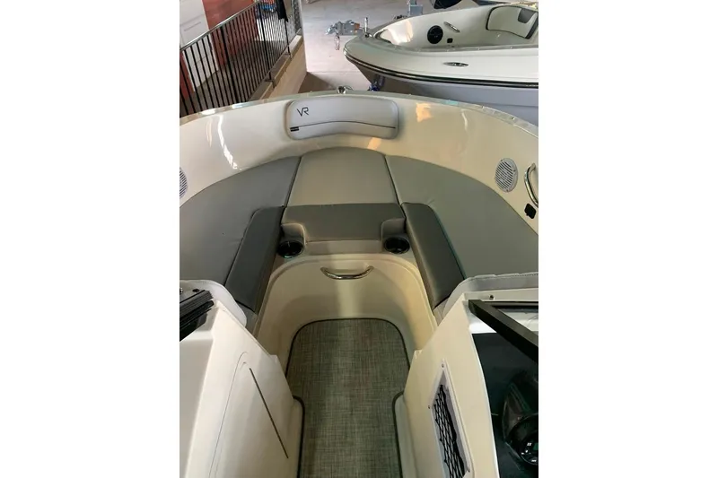 Slide: The Image of 2023 Bayliner VR4 Bowrider OB interior with cushioned seating and cup holders. - 12