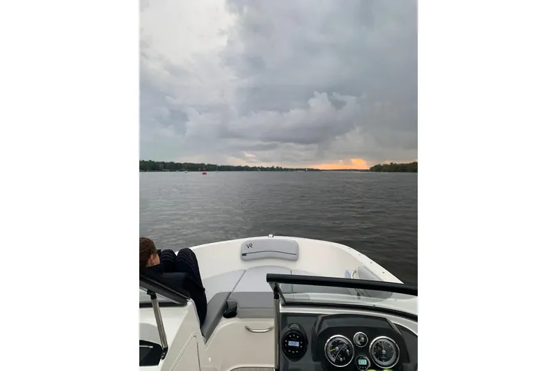 Slide: The Image of 2023 Bayliner VR4 Bowrider OB on a lake at sunset with cloudy sky. - 14