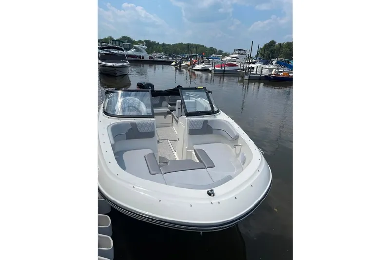Slide: The Image of 2023 Bayliner VR4 Bowrider OB docked at a marina, showcasing sleek design. - 4