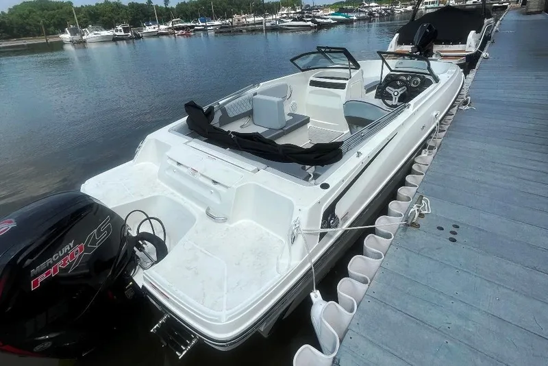 Slide: The Image of 2023 Bayliner VR4 Bowrider OB docked at marina, featuring sleek design and powerful outboard motor. - 5