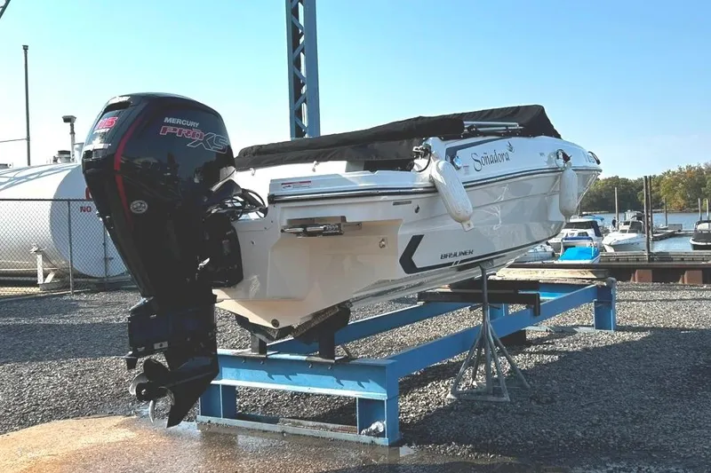 Slide: The Image of 2023 Bayliner VR4 Bowrider OB with Mercury Pro XS engine on display stand. - 7
