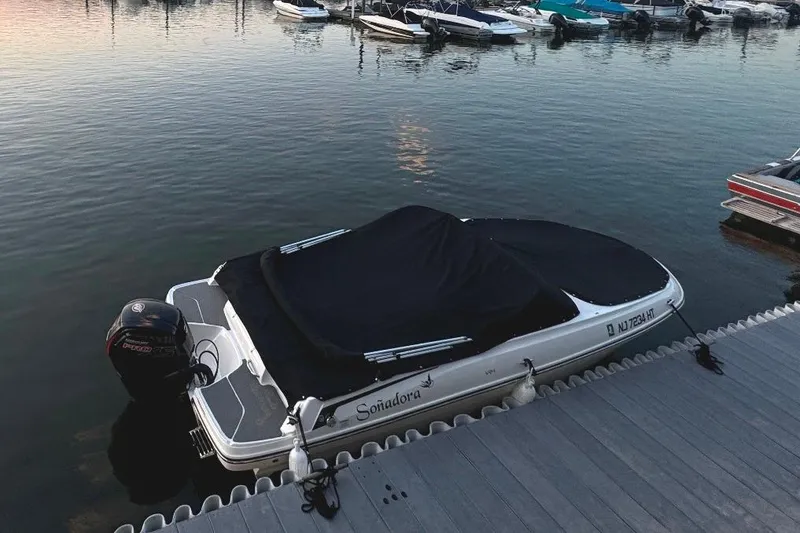 Slide: The Image of 2023 Bayliner VR4 Bowrider OB docked, covered, with outboard motor, at a marina. - 8