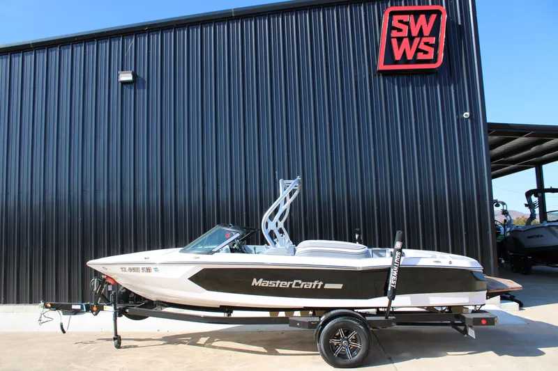The Image of 2022 MasterCraft ProStar boat on trailer, parked outside SWWS building. - 0