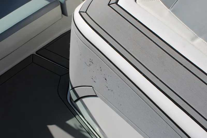 Slide: The Image of 2022 MasterCraft ProStar interior detail with textured gray upholstery and sleek design. - 11