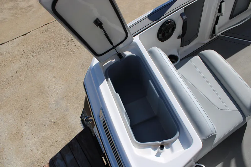 Slide: The Image of 2022 MasterCraft ProStar boat interior with open storage compartment and seating. - 13