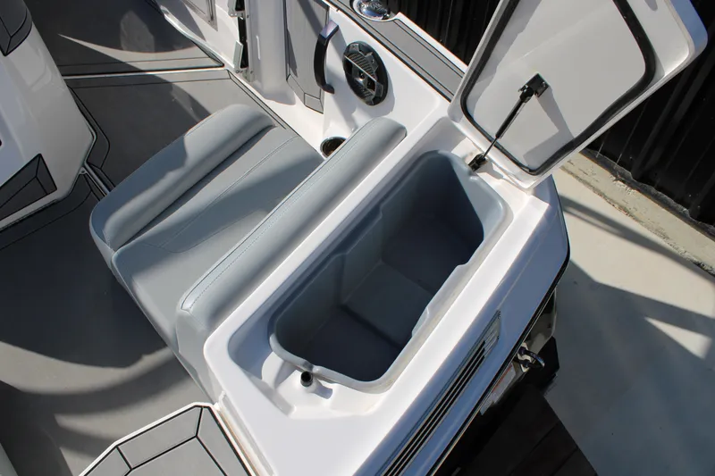 Slide: The Image of 2022 MasterCraft ProStar boat interior with open storage compartment and seating. - 14