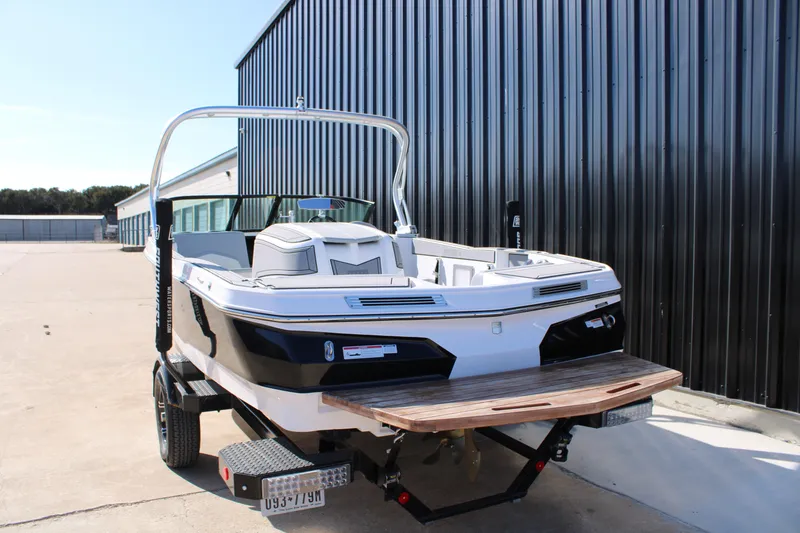 Slide: The Image of 2022 MasterCraft ProStar boat on trailer near metal building. - 17