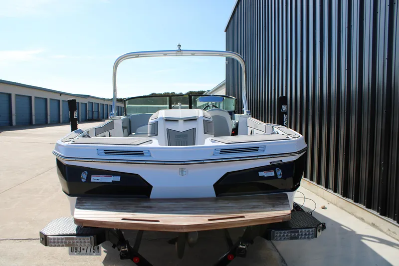 Slide: The Image of 2022 MasterCraft ProStar boat parked near storage units, rear view. - 18