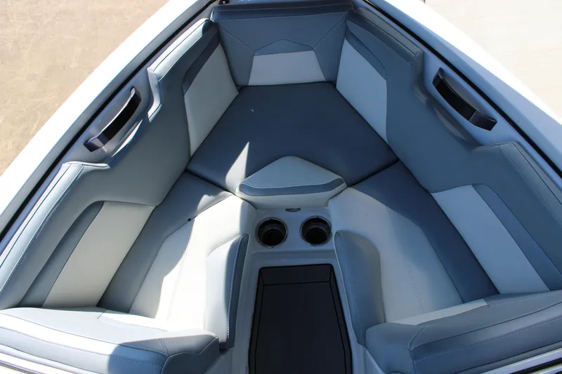 Slide: The Image of 2022 MasterCraft ProStar boat interior with gray seating and cup holders. - 3