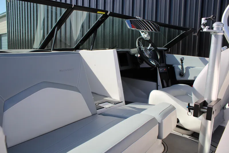 Slide: The Image of 2022 MasterCraft ProStar boat interior with sleek seating and modern dashboard design. - 5