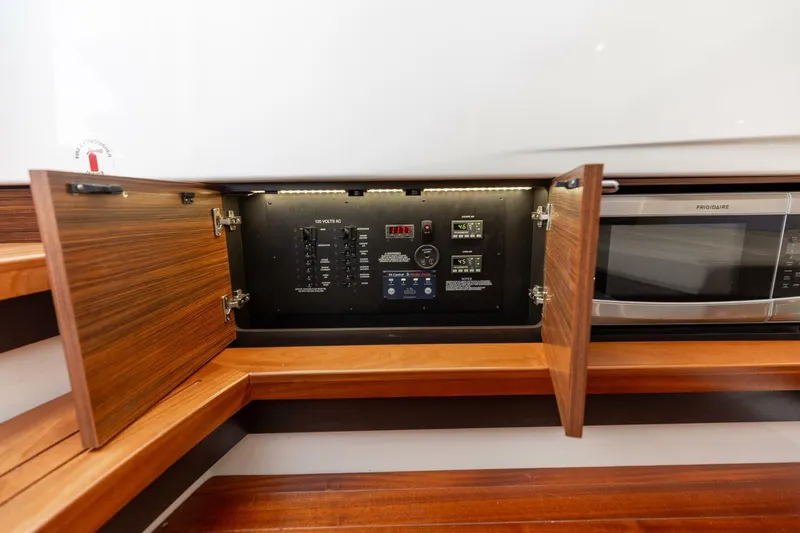 Slide: The Image of 2019 Pursuit S 368 Sport yacht interior with control panel and microwave. - 11