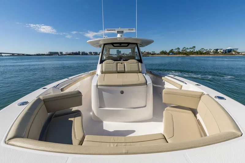 Slide: The Image of 2019 Pursuit S 368 Sport boat with beige seating on calm water. - 15