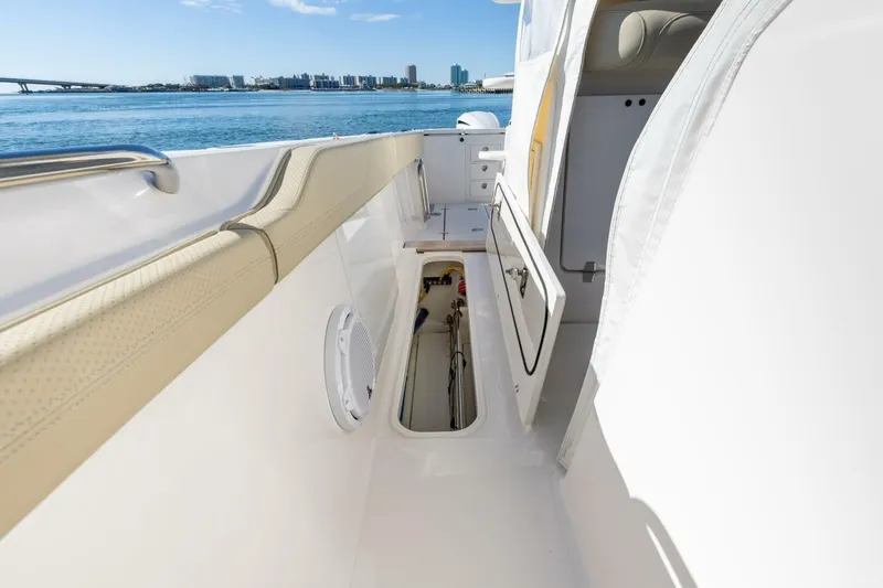 Slide: The Image of 2019 Pursuit S 368 Sport boat interior with open storage compartment, ocean view. - 28