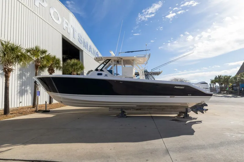 Slide: The Image of 2019 Pursuit S 368 Sport boat displayed outdoors near a large building. - 33