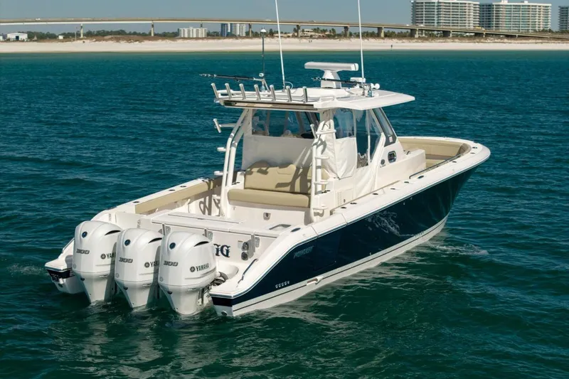 Slide: The Image of 2019 Pursuit S 368 Sport boat with triple Yamaha engines on open water. - 36