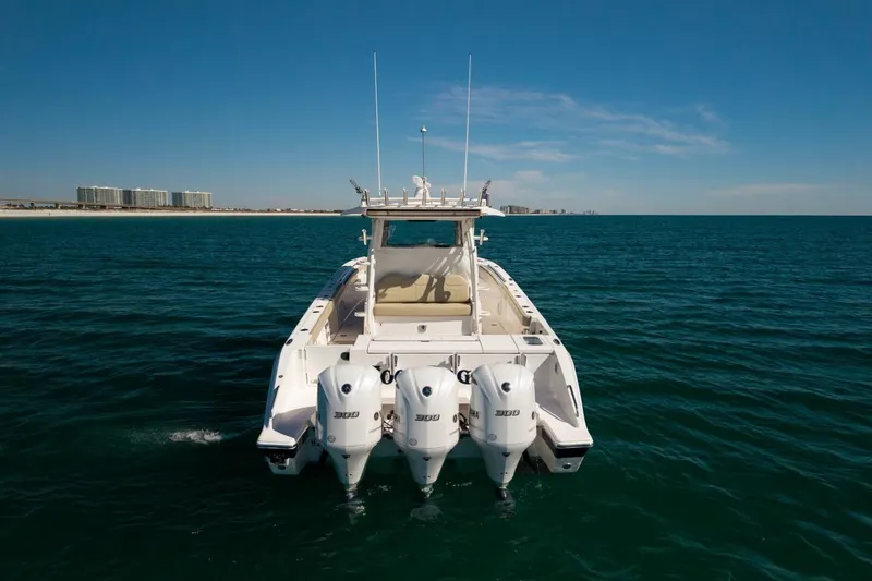 Slide: The Image of 2019 Pursuit S 368 Sport boat with triple engines on open water. - 37