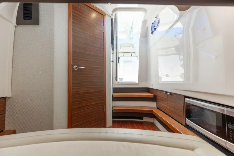 Slide: The Image of Interior of 2019 Pursuit S 368 Sport boat with wooden cabinetry and modern design. - 6