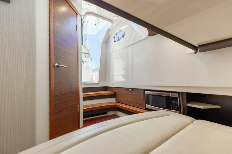 Slide: The Image of Interior of 2019 Pursuit S 368 Sport boat with modern cabinetry and microwave. - 7