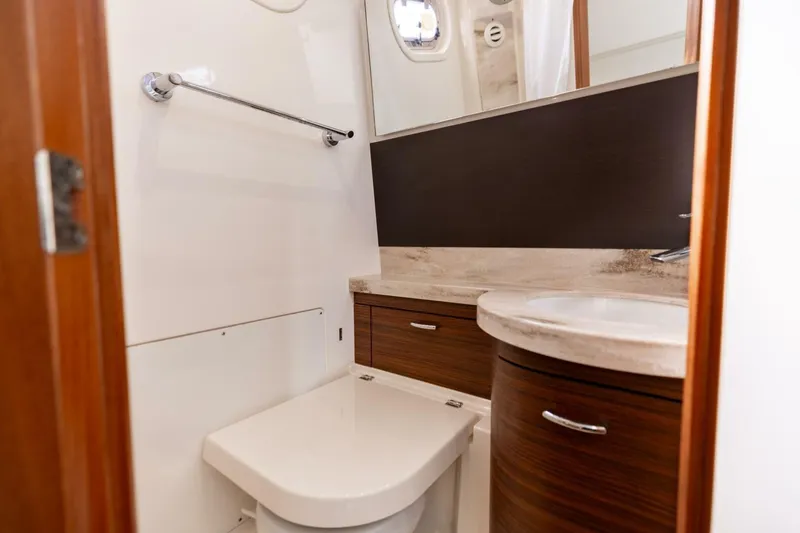 Slide: The Image of Luxurious 2019 Pursuit S 368 Sport yacht bathroom with modern fixtures and wood accents. - 9