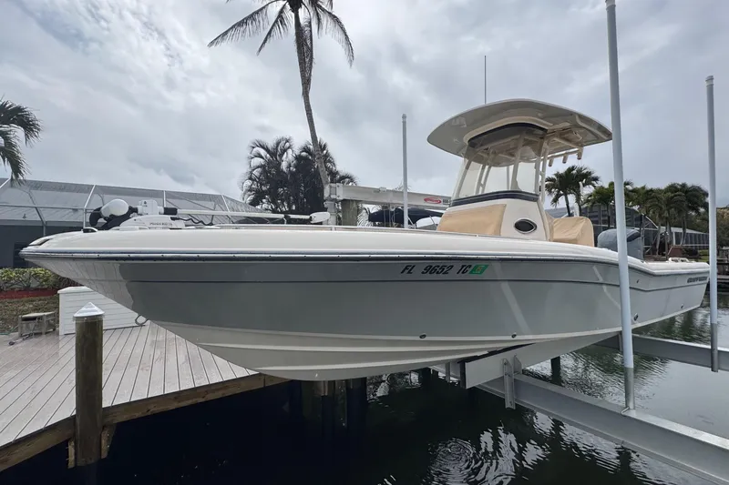 Slide: The Image of 2022 Grady-White 251 Coastal Explorer boat docked near palm trees. - 1