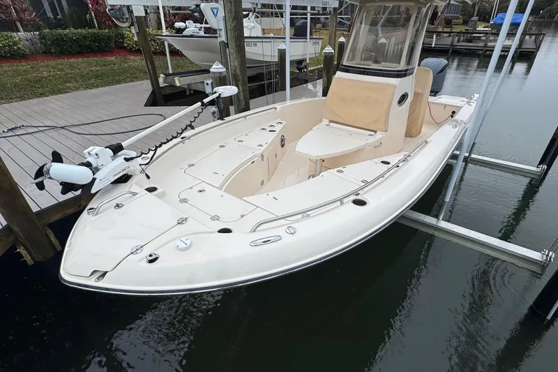 Slide: The Image of 2022 Grady-White 251 Coastal Explorer boat docked on a lift, showcasing sleek design. - 11