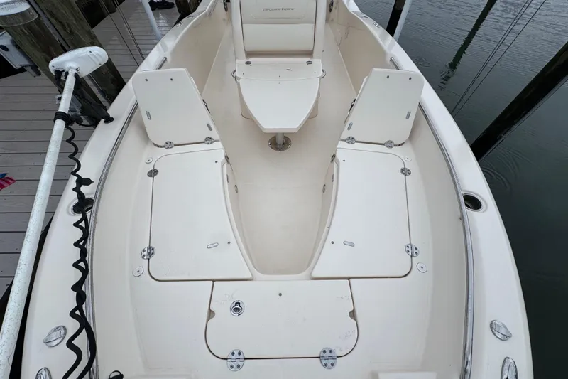 Slide: The Image of 2022 Grady-White 251 Coastal Explorer boat interior with storage compartments and seating. - 13