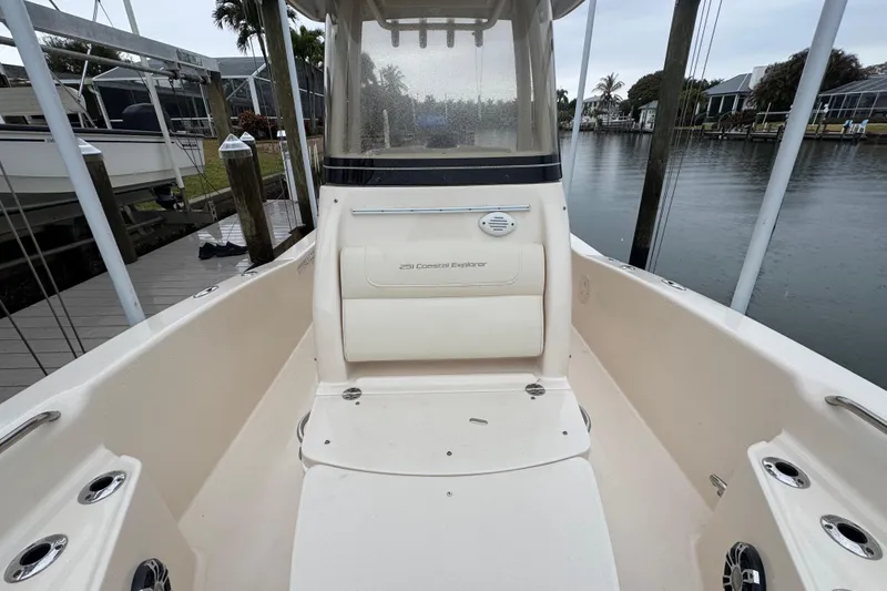 Slide: The Image of 2022 Grady-White 251 Coastal Explorer boat interior, docked by a calm waterfront. - 17