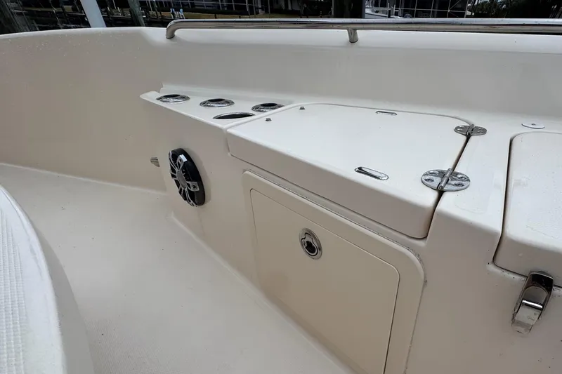 Slide: The Image of 2022 Grady-White 251 Coastal Explorer boat interior with storage compartments and speaker. - 18