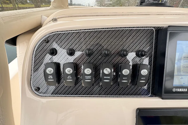 Slide: The Image of Control panel of 2022 Grady-White 251 Coastal Explorer boat with switches and Yamaha display. - 33