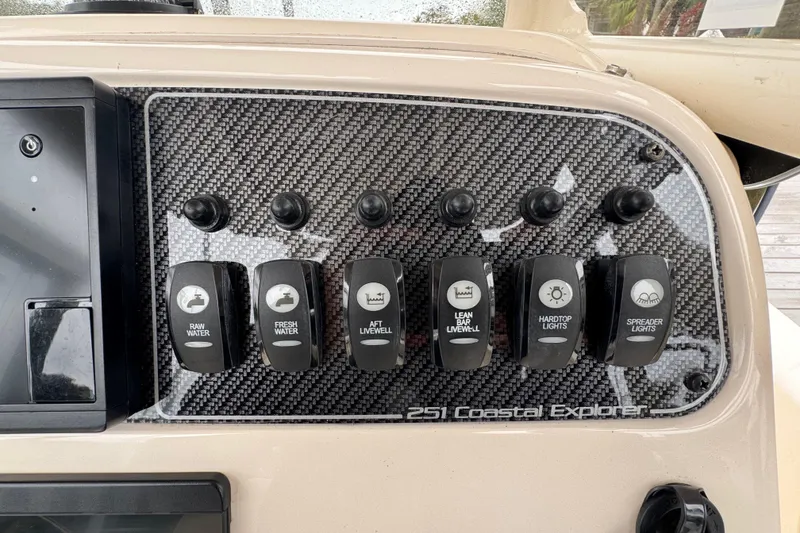 Slide: The Image of Control panel of 2022 Grady-White 251 Coastal Explorer with various switches. - 35
