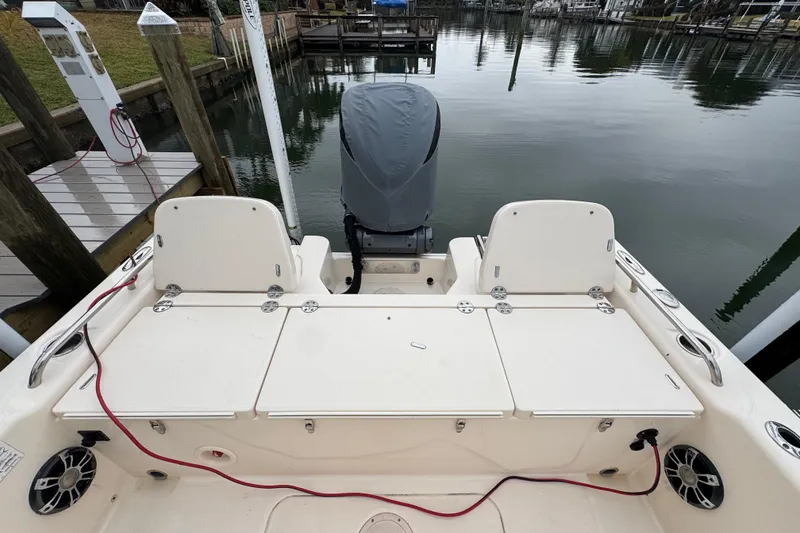 Slide: The Image of 2022 Grady-White 251 Coastal Explorer boat docked, featuring spacious seating and covered engine. - 41