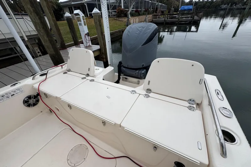 Slide: The Image of 2022 Grady-White 251 Coastal Explorer boat docked, featuring rear seating and engine cover. - 42