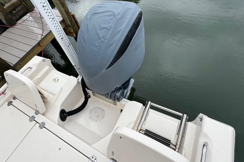 Slide: The Image of 2022 Grady-White 251 Coastal Explorer boat with covered outboard motor at dock. - 43