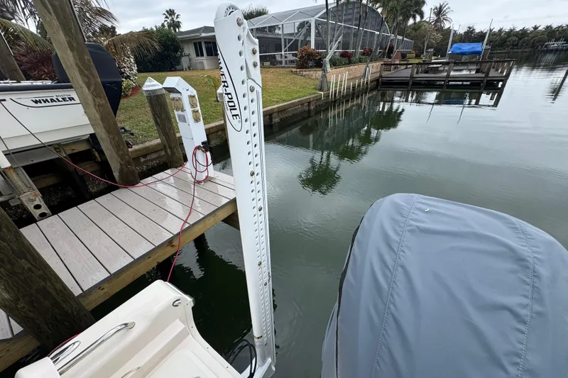 Slide: The Image of 2022 Grady-White 251 Coastal Explorer docked near a calm waterfront. - 46
