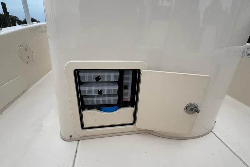 Slide: The Image of Storage compartment on 2022 Grady-White 251 Coastal Explorer boat with organized tackle boxes. - 49