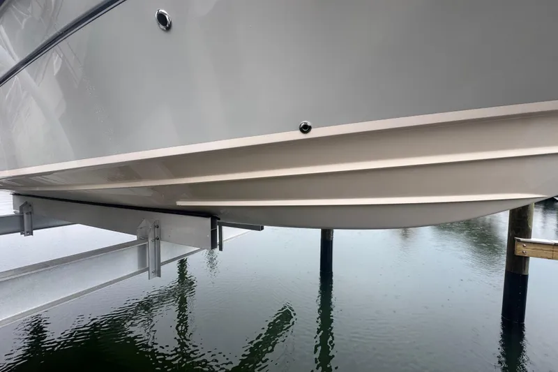 Slide: The Image of 2022 Grady-White 251 Coastal Explorer boat hull on lift over water. - 5