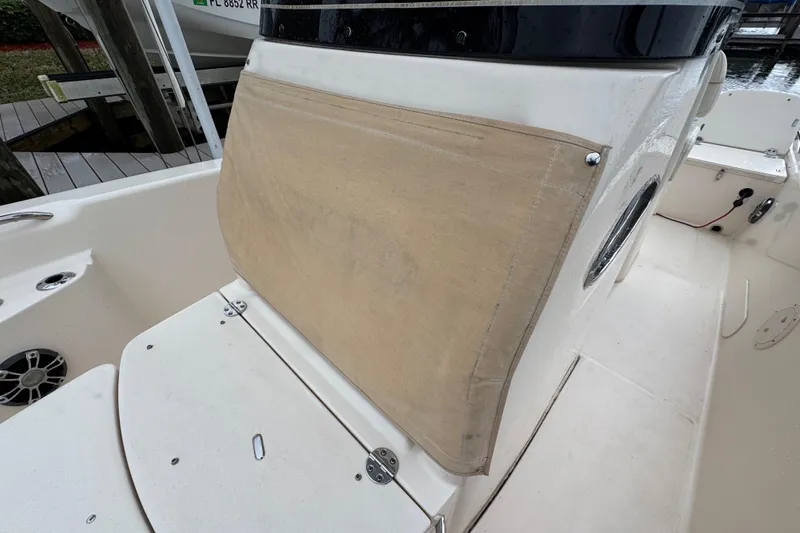 Slide: The Image of 2022 Grady-White 251 Coastal Explorer boat interior with beige seating and speaker. - 55