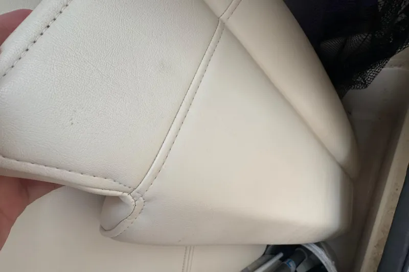 Slide: The Image of White leather seat detail on 2022 Grady-White 251 Coastal Explorer boat. - 59