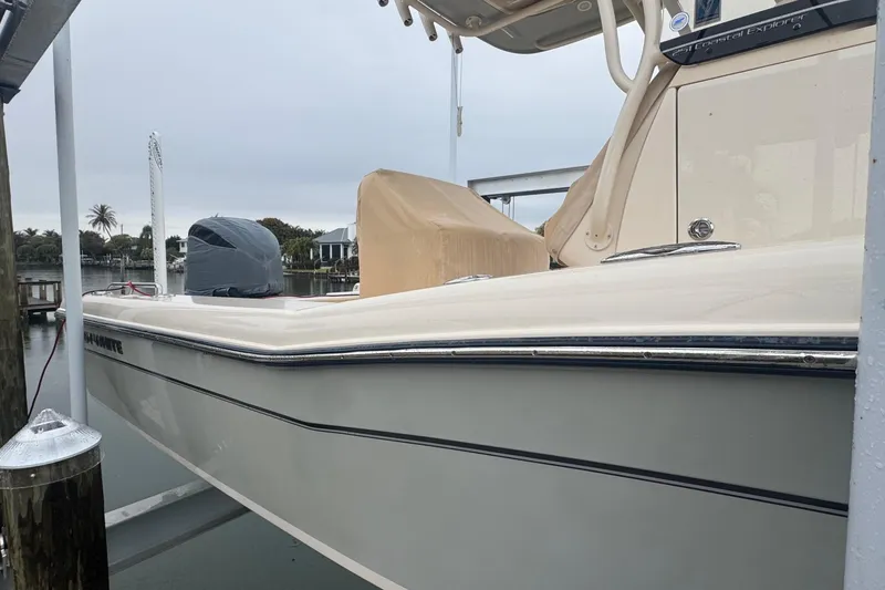 Slide: The Image of 2022 Grady-White 251 Coastal Explorer boat docked, side view with covered seats. - 6