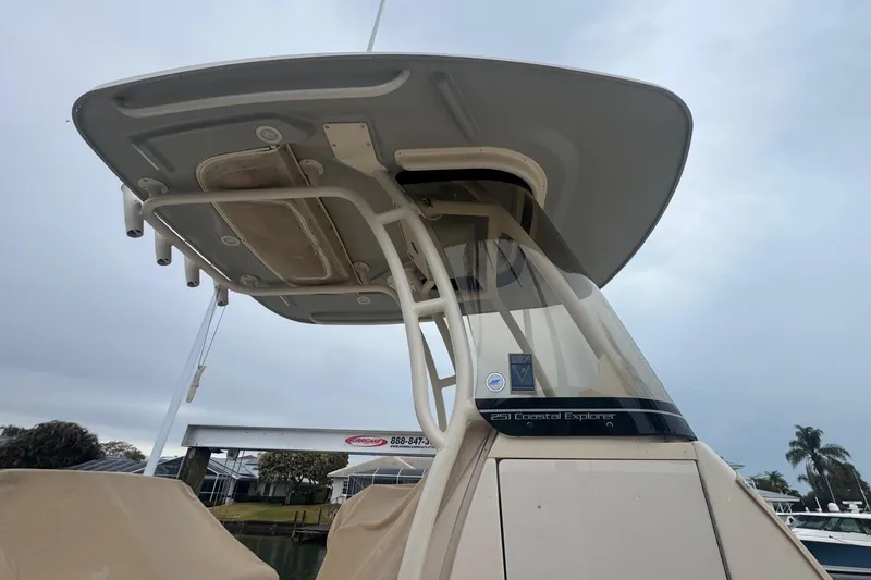 Slide: The Image of 2022 Grady-White 251 Coastal Explorer boat with T-top, docked under cloudy sky. - 7