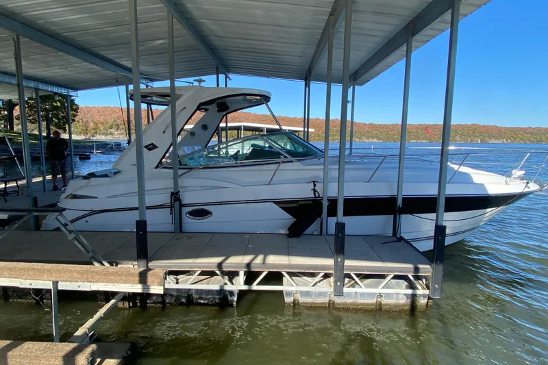 The Image of 2017 Monterey 355 Sport Yacht docked under a covered marina on a sunny day. - 0