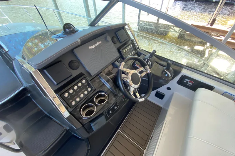 Slide: The Image of Cockpit of 2017 Monterey 355 Sport Yacht with steering wheel and control panel. - 14
